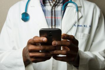 Doctor with mobile phone in their hand