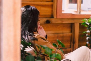 Woman sitting in a chair while thinking