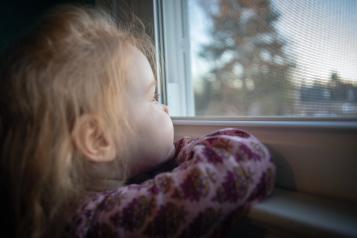 Young child looking out the window