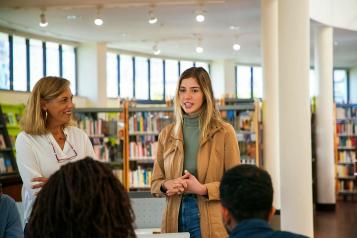 People talking in a library 