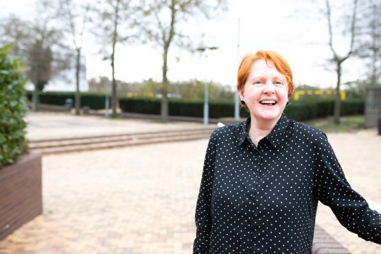 Lady in a black and white polka dot blouse