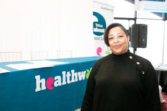 Lady standing in front of a Healthwatch banner