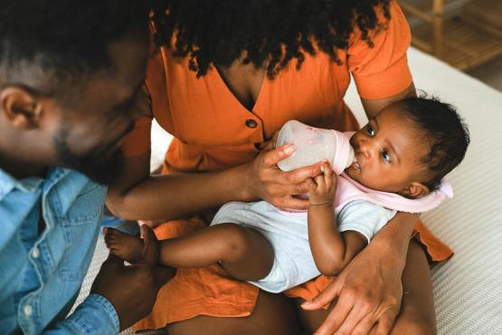 Mother and father feeding their baby