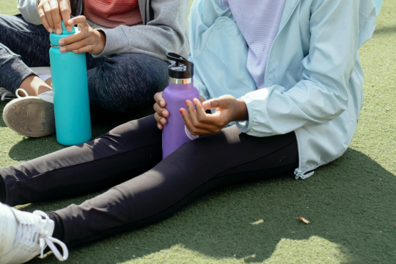 Tired girls resting on sports ground