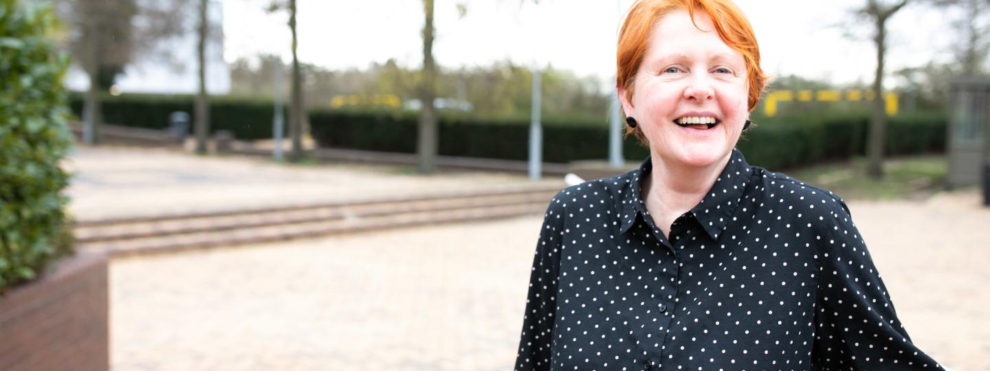 Lady in a black and white polka dot blouse