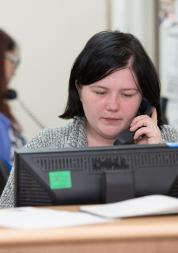 GP receptionist talking on the phone