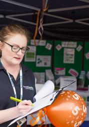 Healthwatch staff member taking down notes from a member of the public
