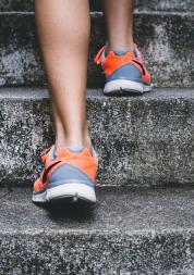 Lady running up steps in exercise shoes