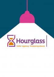 Hourglass logo under a spotlight